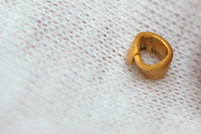 A 15-centigrams gold bead is pictured in village of Yunatsite